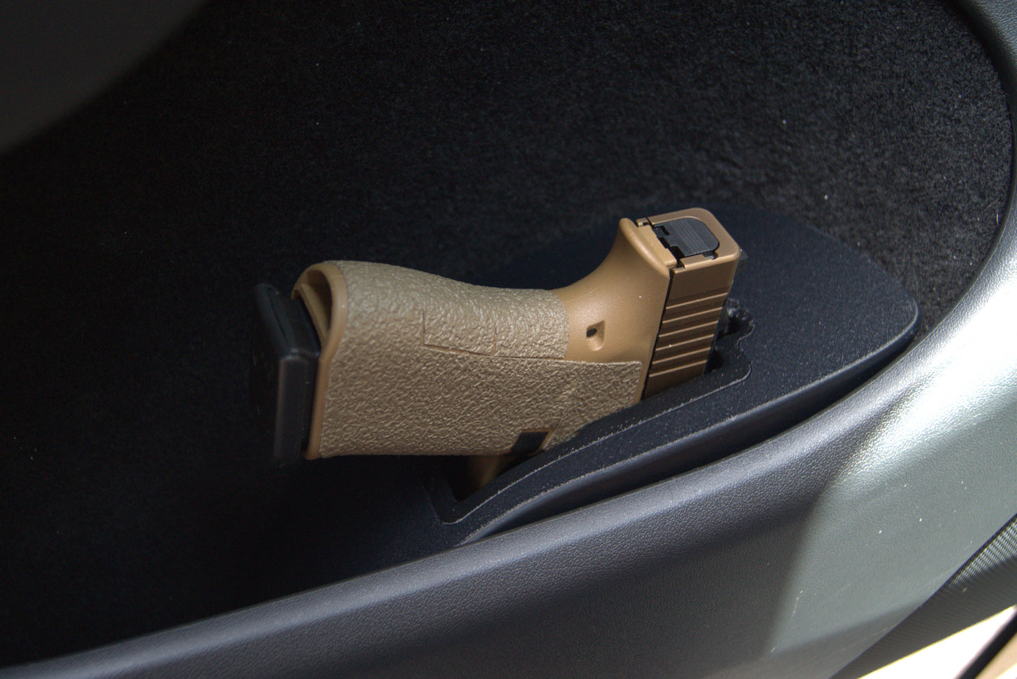 Tesla Model Y door holster installed in driver door pocket