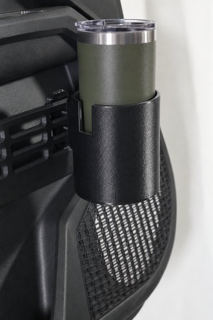 An olive green insulated travel tumbler with a clear lid, mounted in a black textured holder on a Toyota door panel.